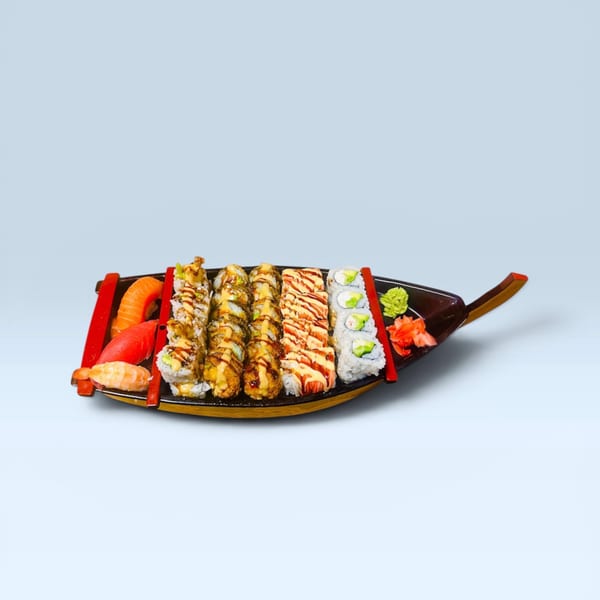 Assortment of sushi rolls, nigiri, ginger, and wasabi on a decorative boat platter.